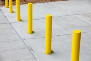 parking bollards painted yellow in concrete