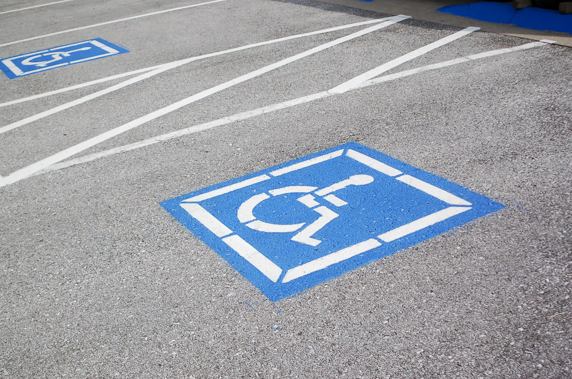 parking lot striping for ada compliance for cincinnati businesses, including a wheelchair accessible logo on asphalt