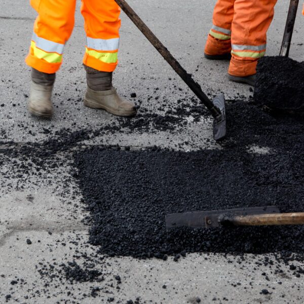 cincinnati asphalt workers performing pothole repair on a roadway in greater cincinnati