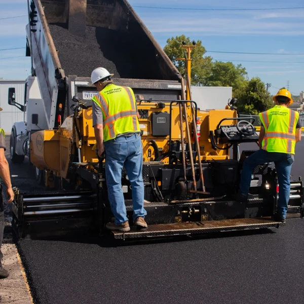 paving crew performing an asphalt paving project in a commercial parking lot