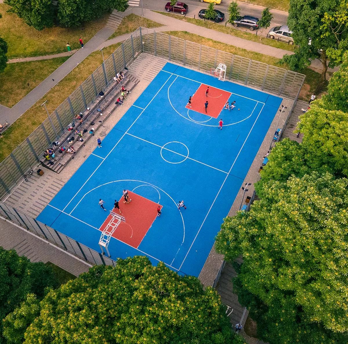 aerial view of people playing basketball on a basketball court