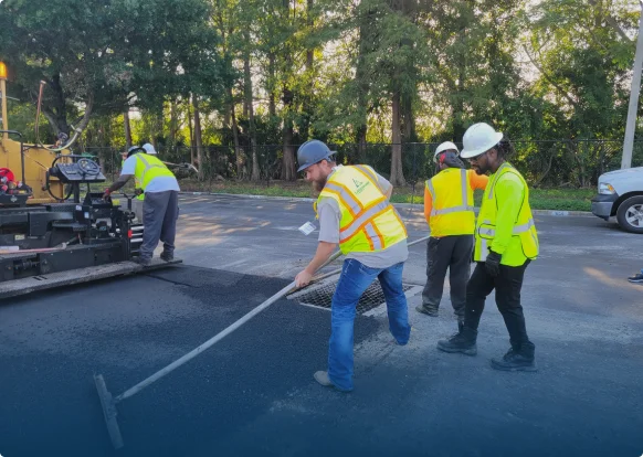 workers adding asphalt surface to bass pro parking lot