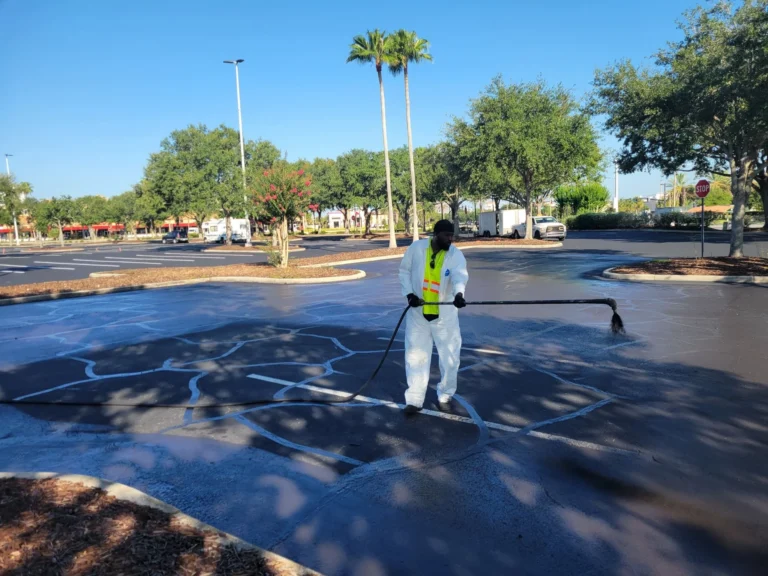 worker adding sealcoating to asphalt bass pro parking lot