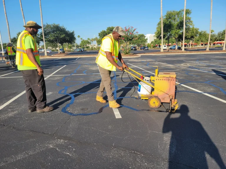worker doing crack filling to bass pro parking lot