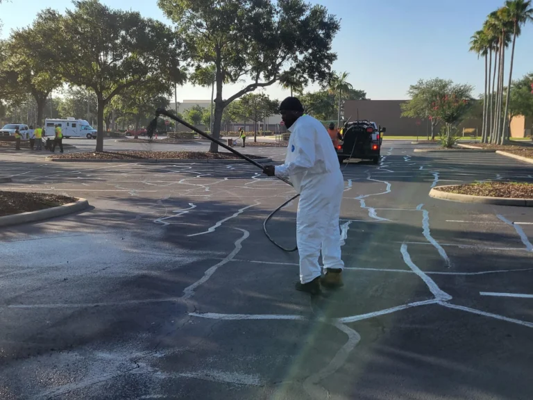worker adding sealcoating to bass pro parking lot