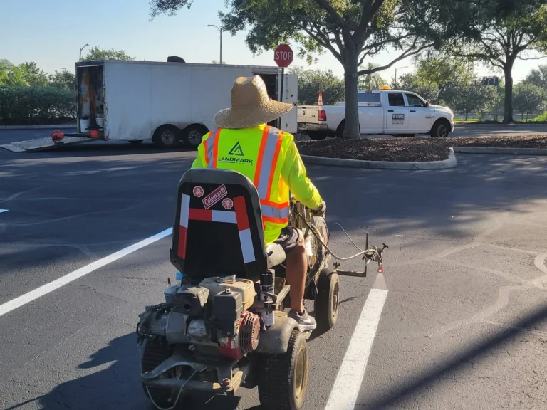 worker adding pavement striping to bass pro parking spots