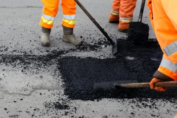 cincinnati asphalt workers performing pothole repair on a roadway in greater cincinnati